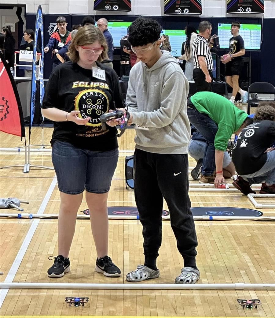 Aleura Hughes, ASD, collaborates with another competitor during aerial robotics.